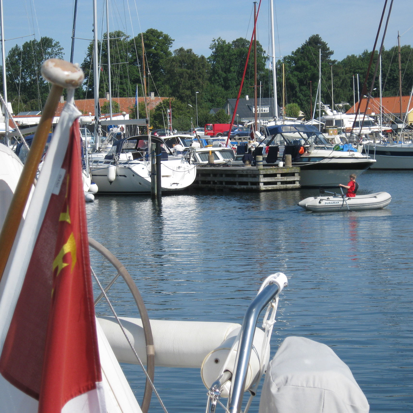 Indsejling til lystbådehavnen. I forgrunden både. I baggrunden huse på havnen.
